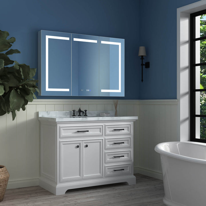 Modern LED bathroom mirror with white vanity and freestanding tub